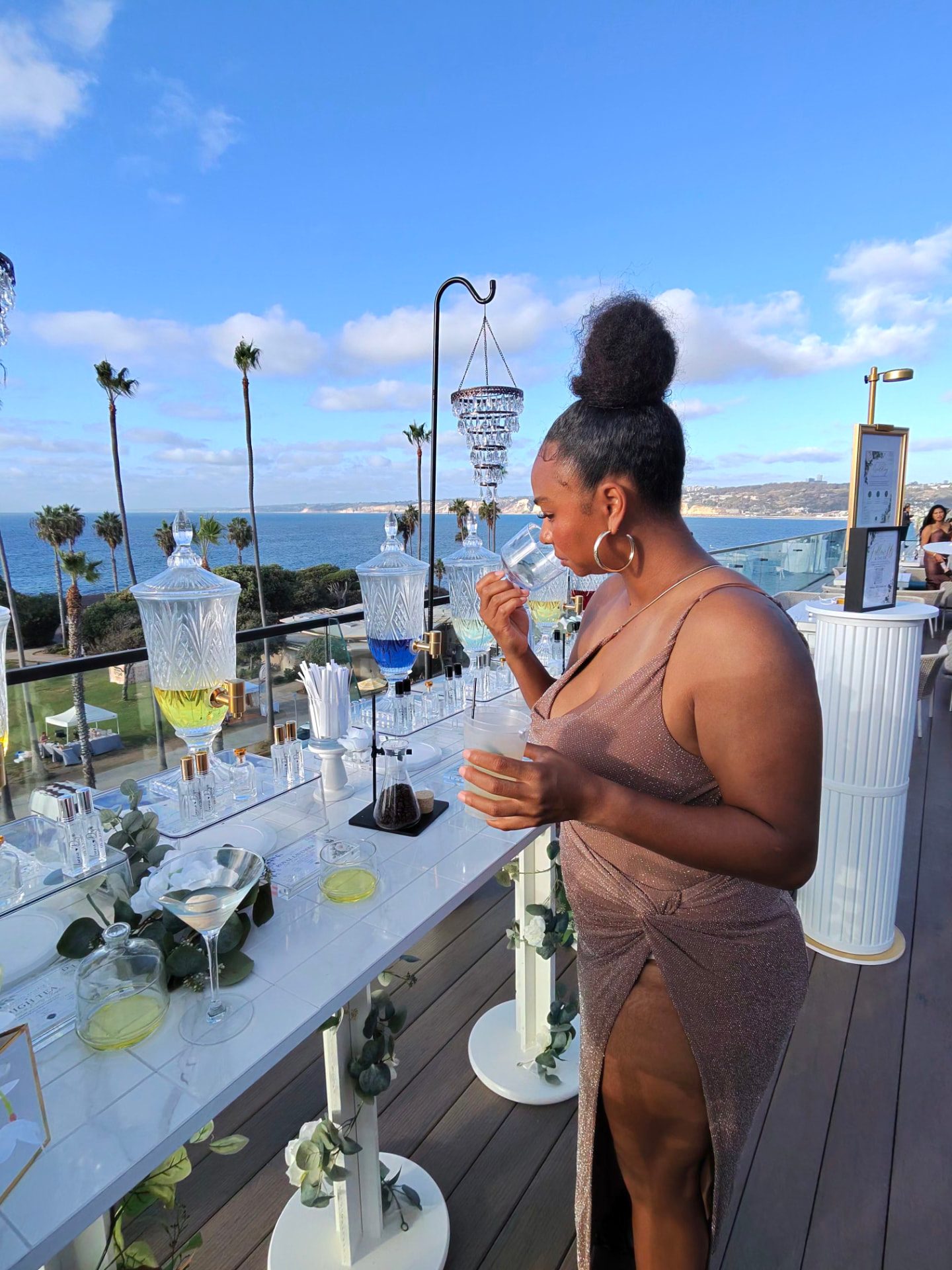 Guest smelling a fragrance at the oceanfront bar