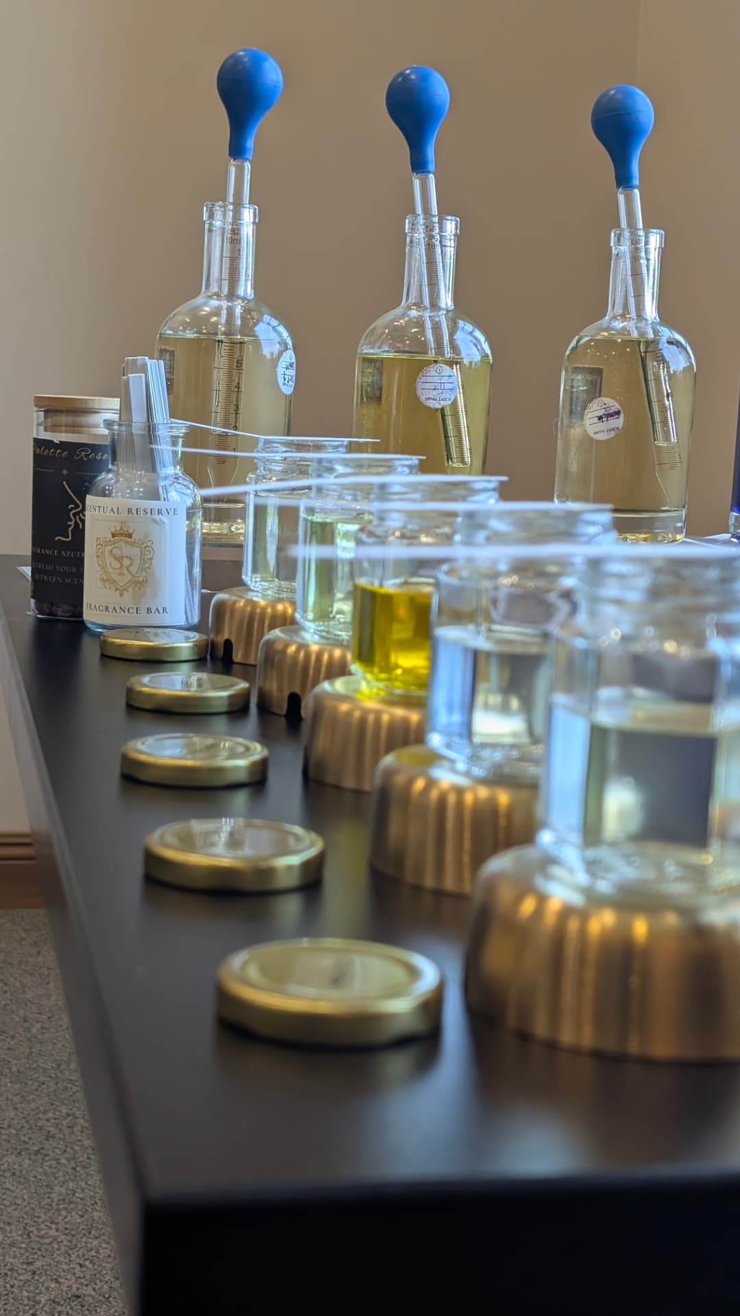 Blending bottles with blue pipettes during a fragrance creation