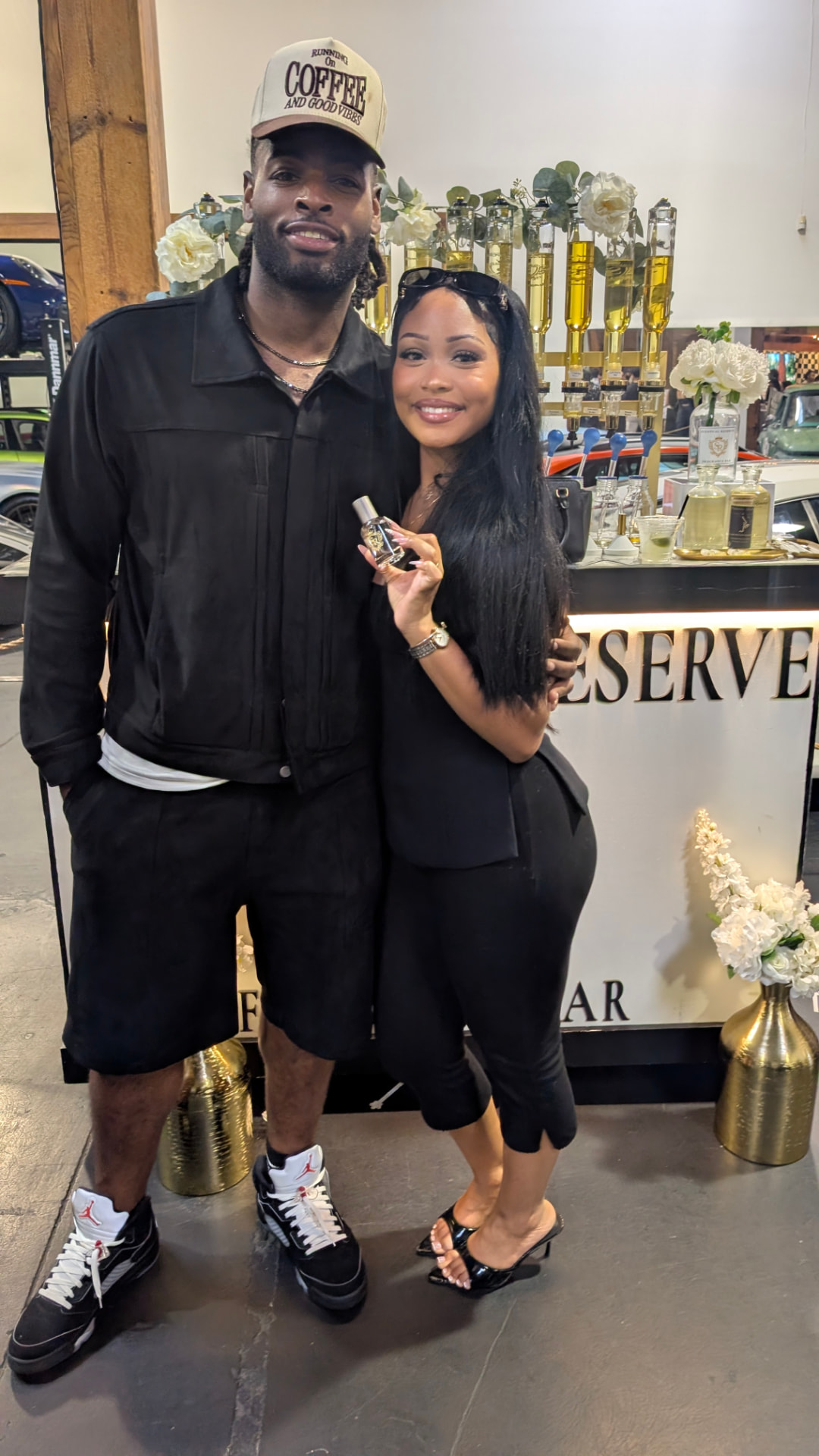 A couple with their new fragrance at an automotive-event Scentual Reserve bar